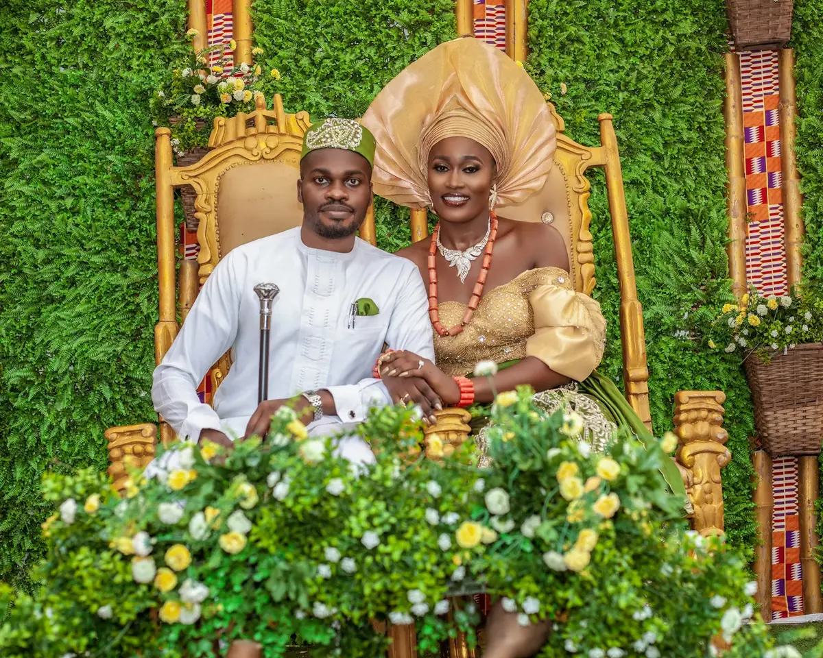 Wedding couple in traditional Nigerian attire on golden throne